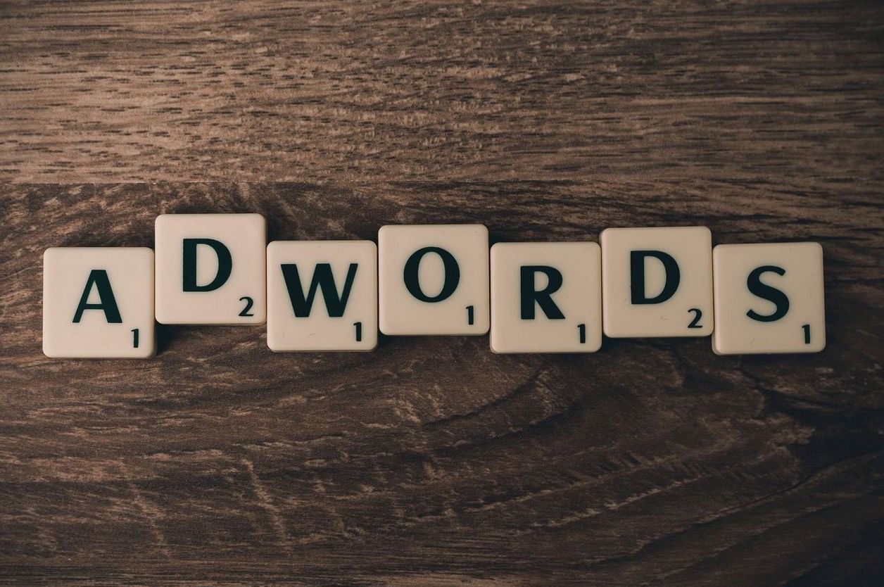 Scrabble tiles spelling AdWords on a wooden table